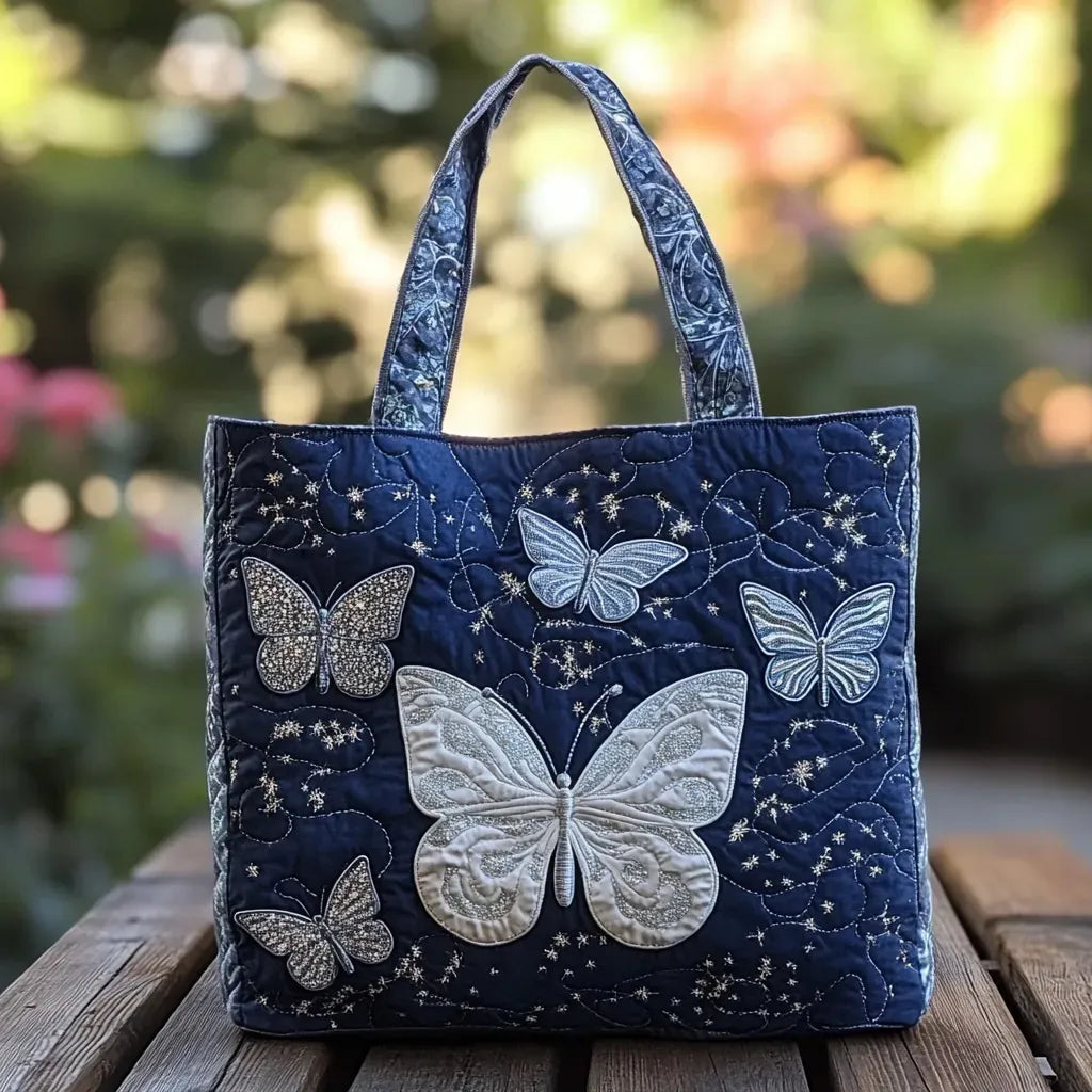 Bolso tote acolchado azul marino con mariposas blancas y plateadas